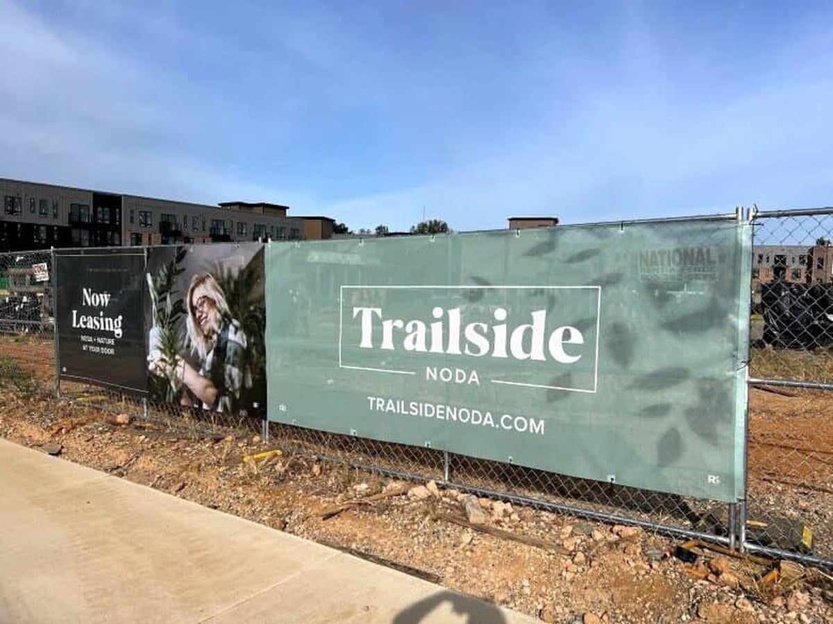 Now leasing mesh banners on a construction site fence